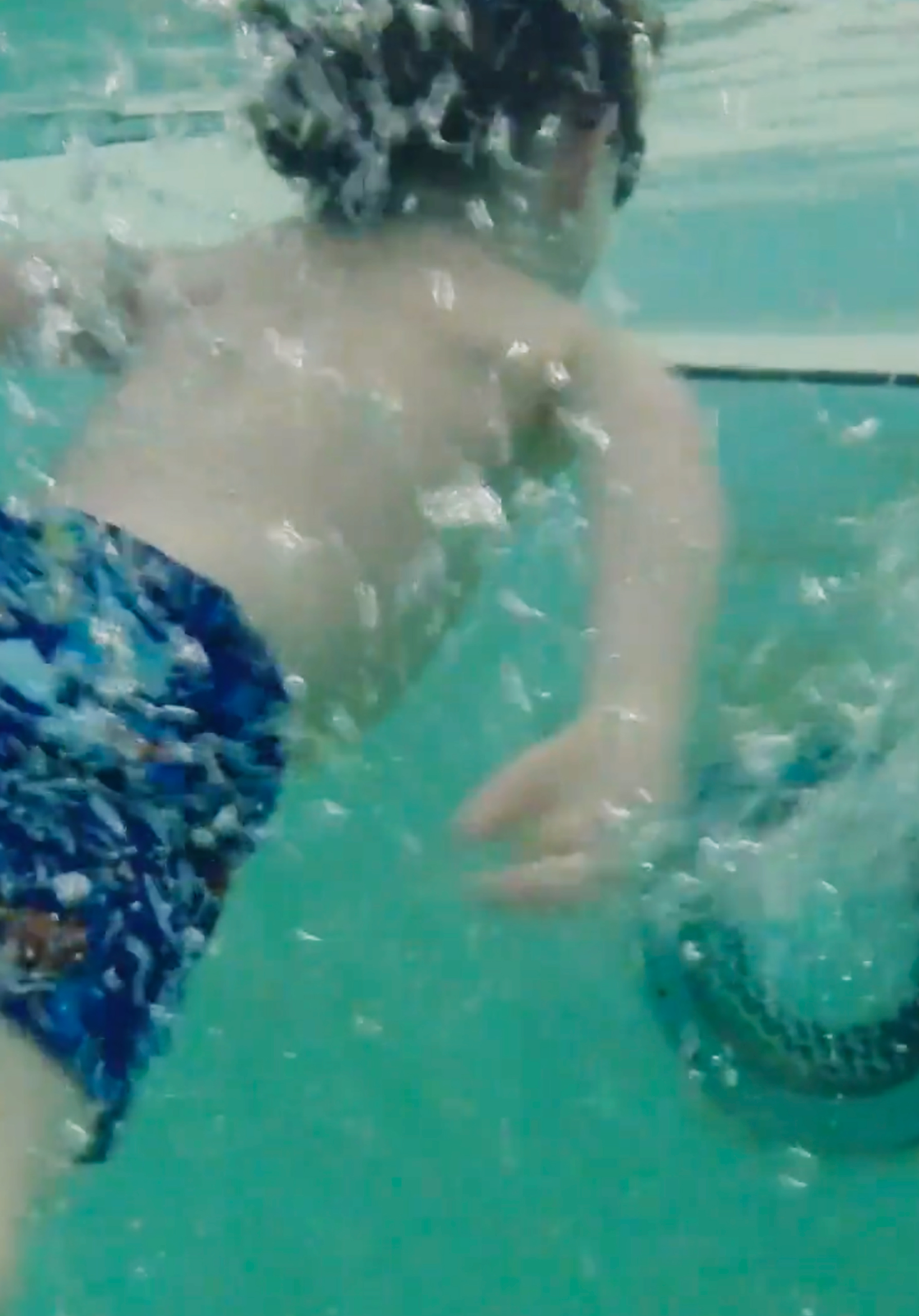 Boy underwater swimming in pool